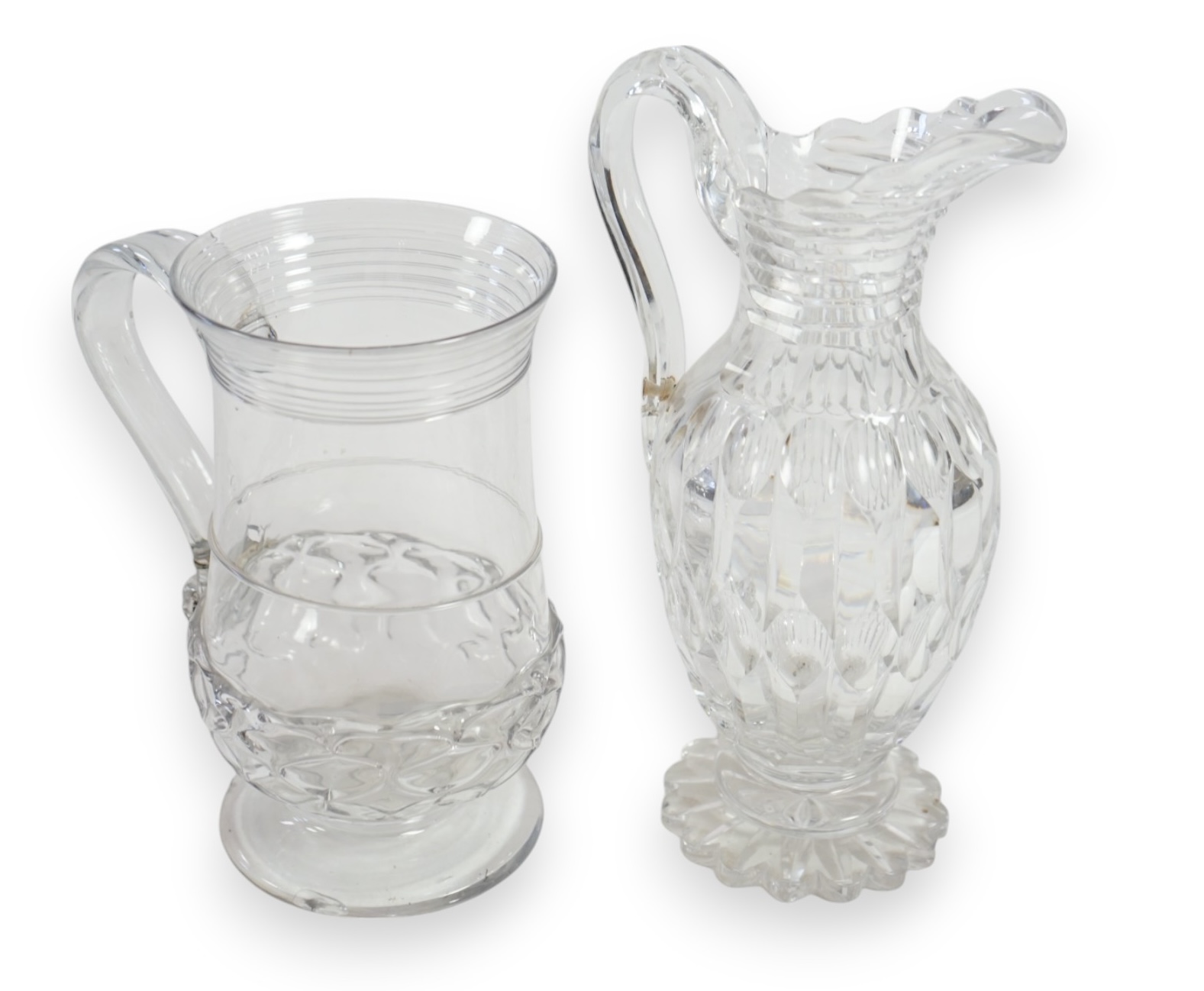 An 18th century wrythen moulded glass ale jug